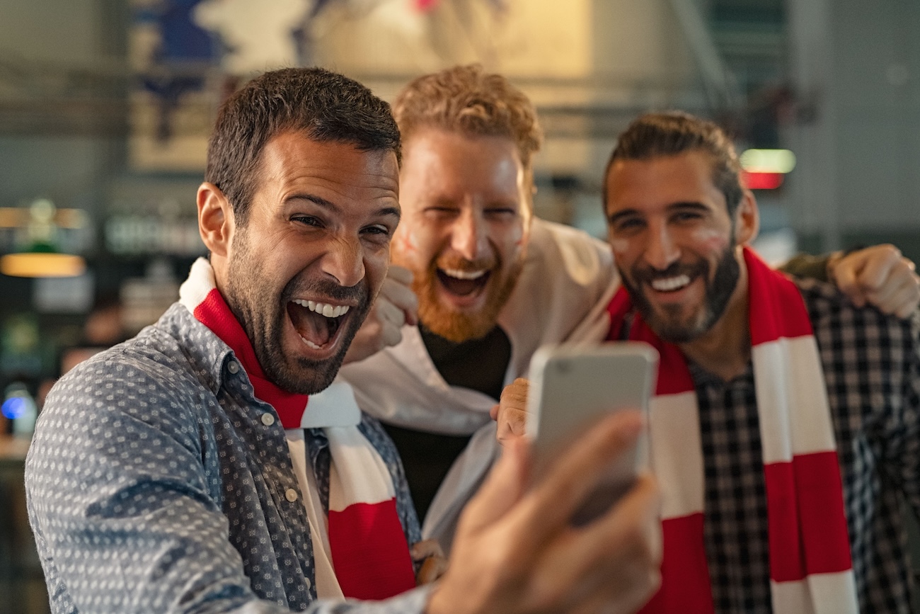 excited men watching football streaming