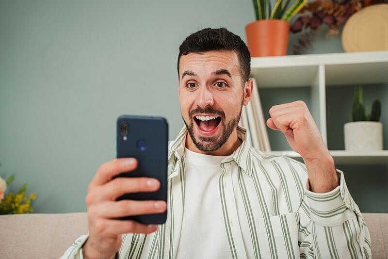 A man is celebrating after placing a successful bet.