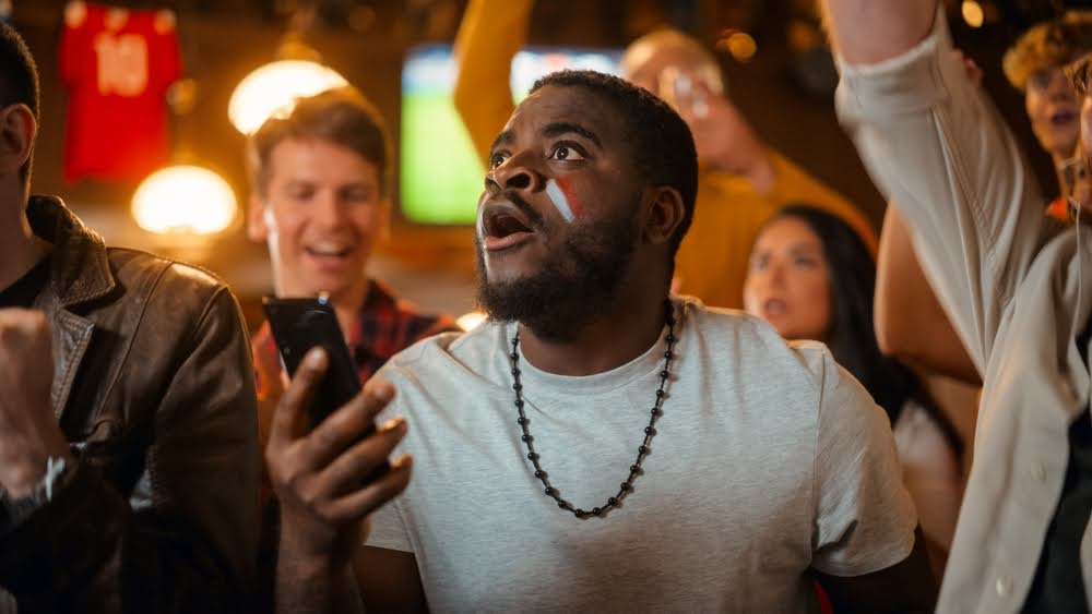 A man watching a football game after betting on fantasy sports.