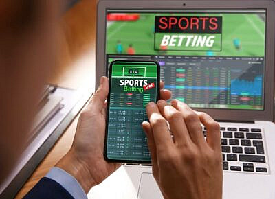 A person using a phone to check live betting odds.