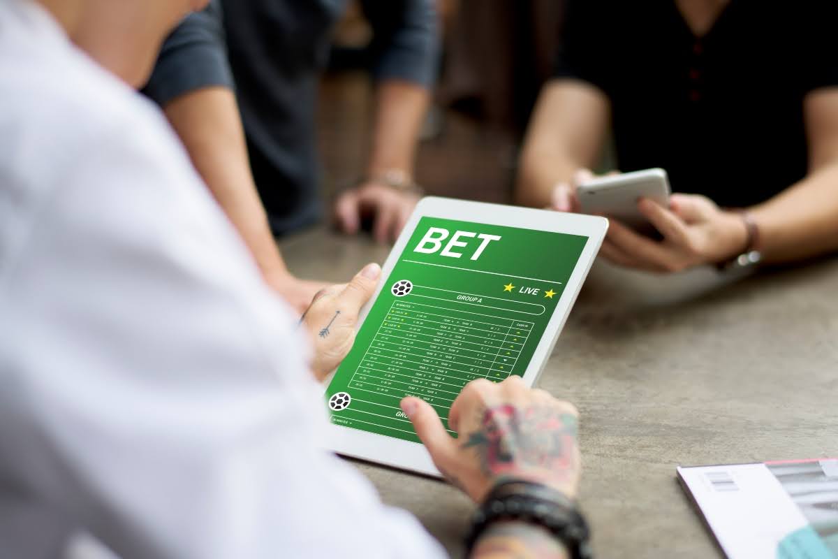Man using betting software for college player prop bets.