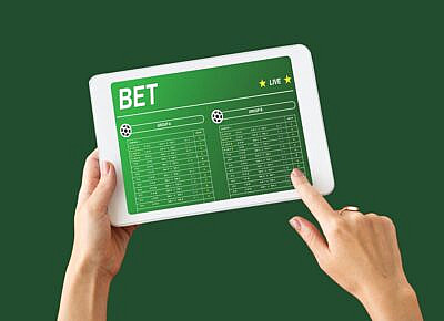 A person using pay-per-head software to parlay player props.